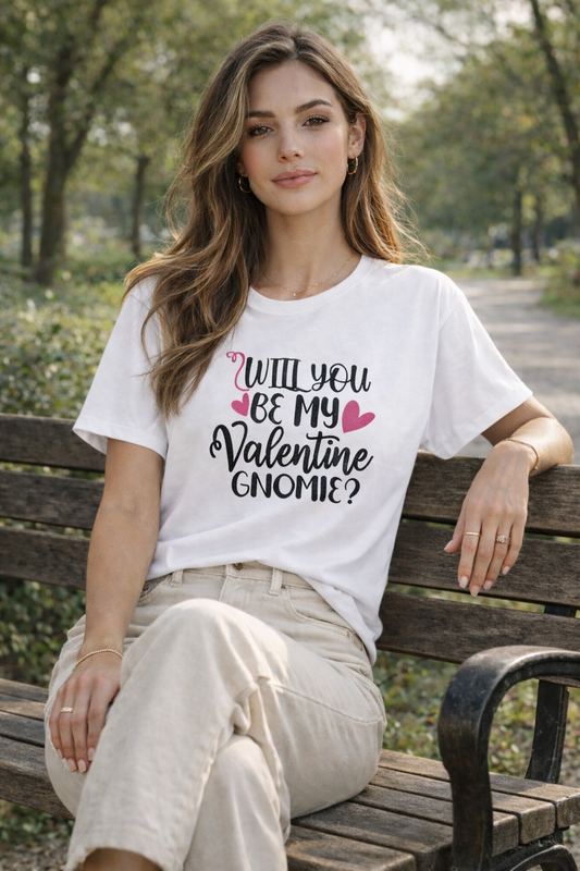 Woman sitting on a bench wearing a white t-shirt with a Valentine's Day message.