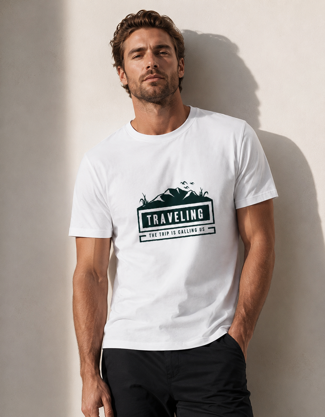 Man wearing a white t-shirt with a 'Traveling' graphic design against a plain background