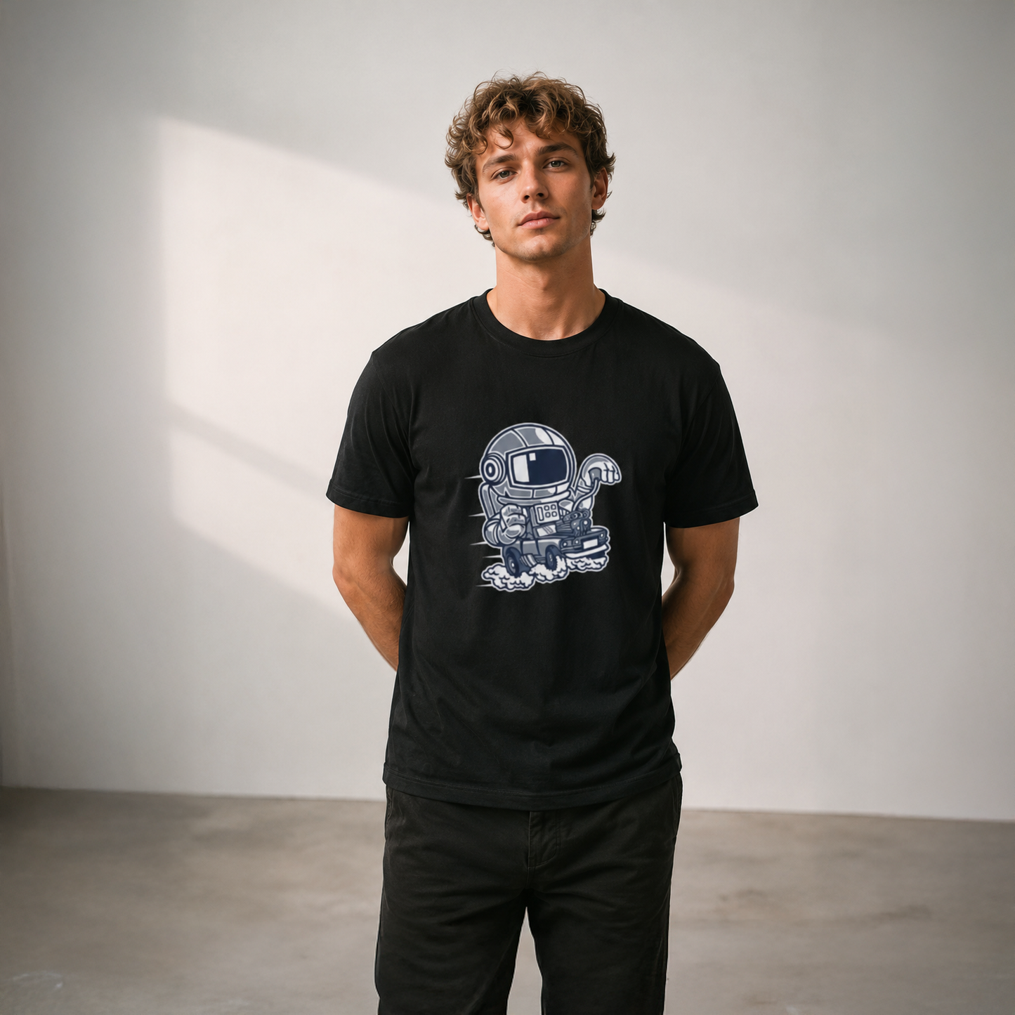 Man wearing a black t-shirt with a robot graphic design against a plain background