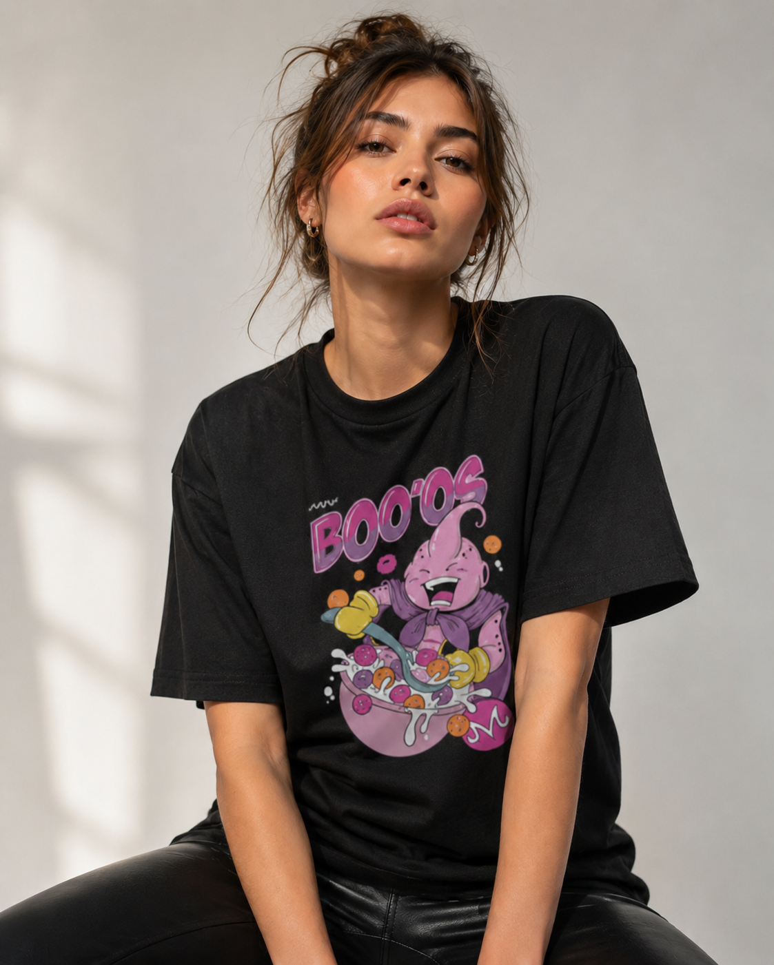 Person wearing a black t-shirt with a colorful graphic design on a neutral background