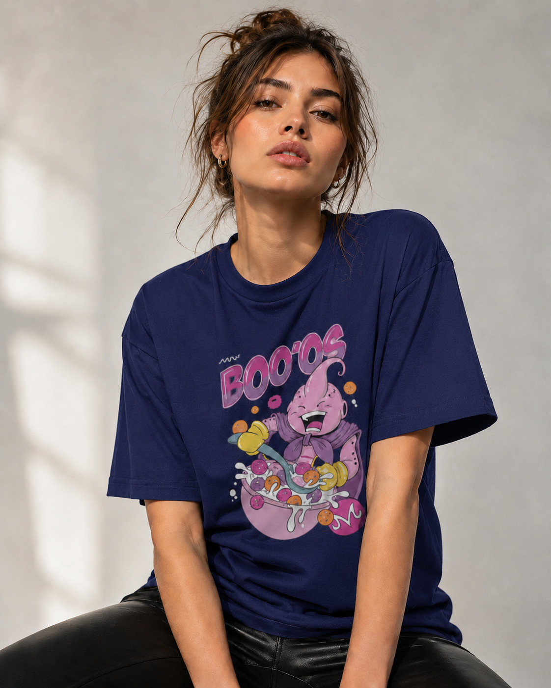 Person wearing a navy blue t-shirt with a colorful graphic design on a neutral background