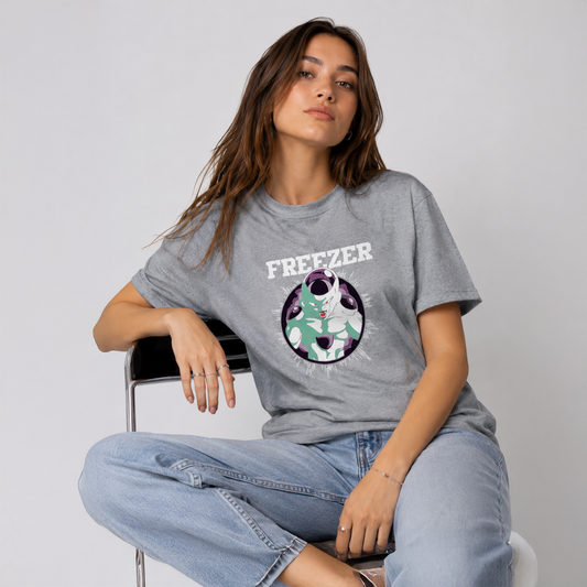 Woman wearing a gray t-shirt with a graphic design and text, sitting on a chair against a plain background.