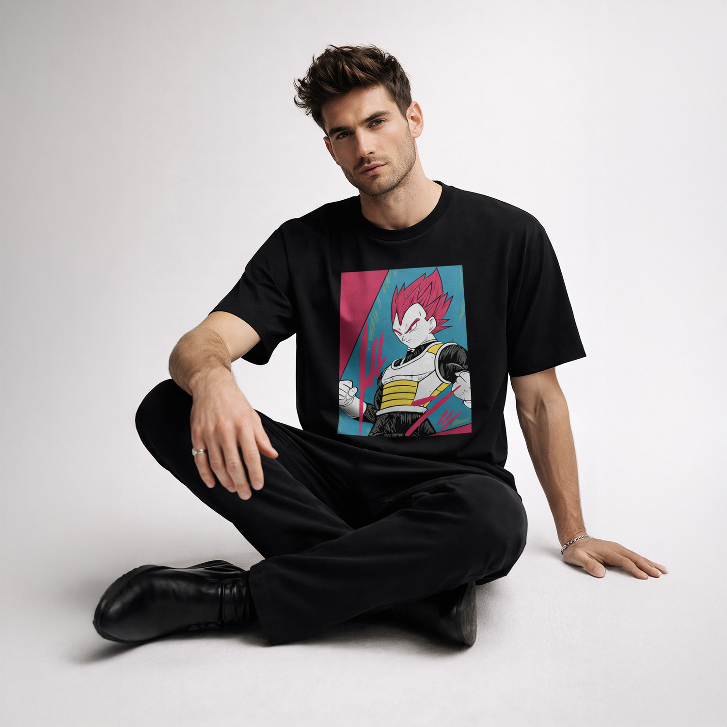 Man wearing a black t-shirt with a colorful graphic design on a white background