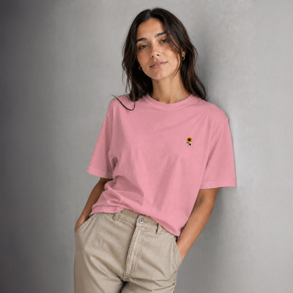 Woman wearing a pink t-shirt with a small design on a gray background
